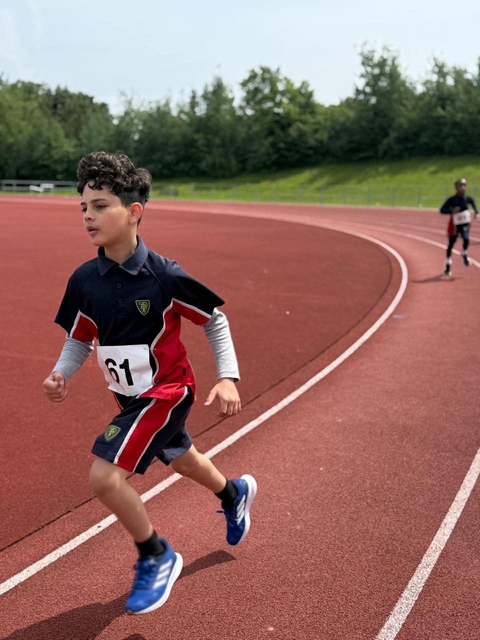 A pupil sprints down the track on sports day.