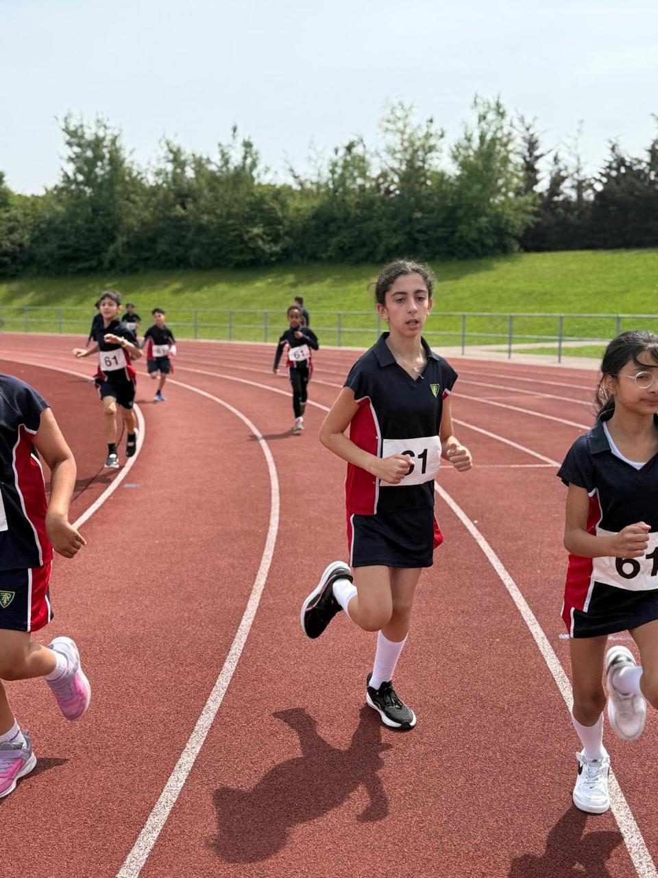 A pupil races along the running track on sports day.