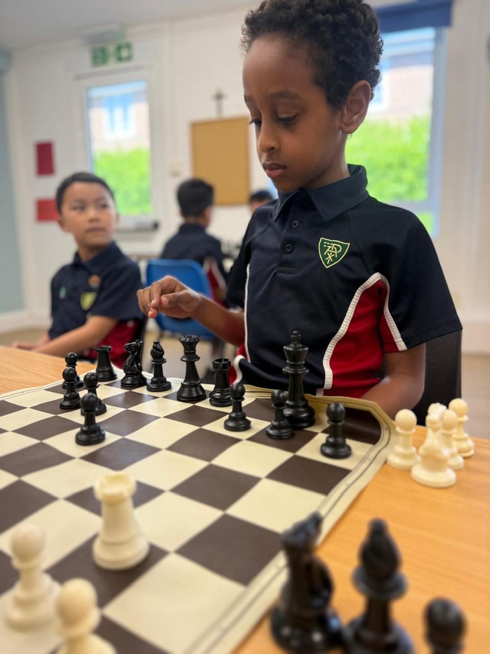 A pupil makes a move in a chess match.