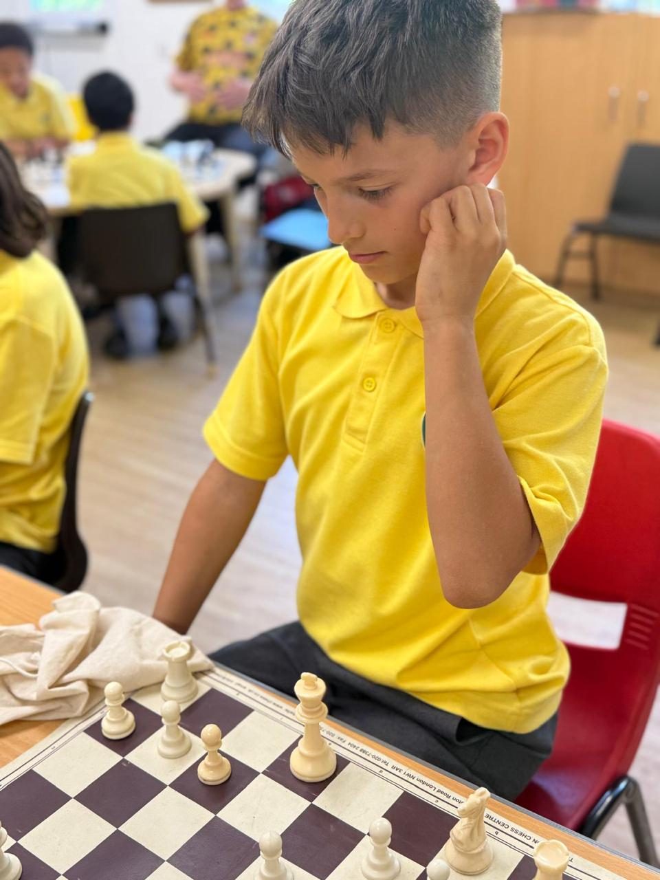A pupil concentrates on his chess game.