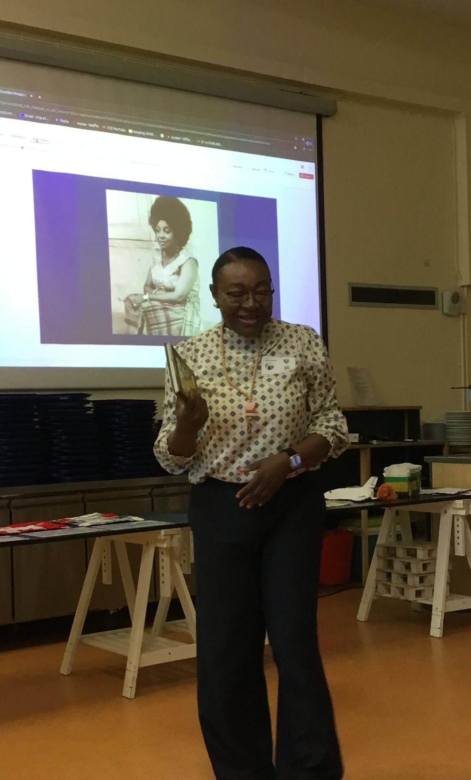 Mrs Sophia Ovonlen holding up her book during the assembly