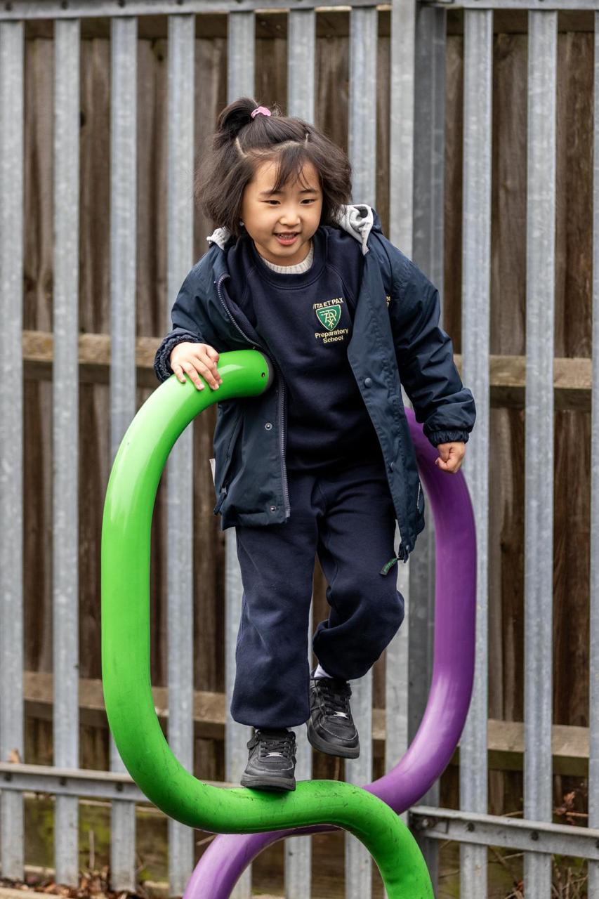 Nursery child climbing outdoors at Vita et Pax