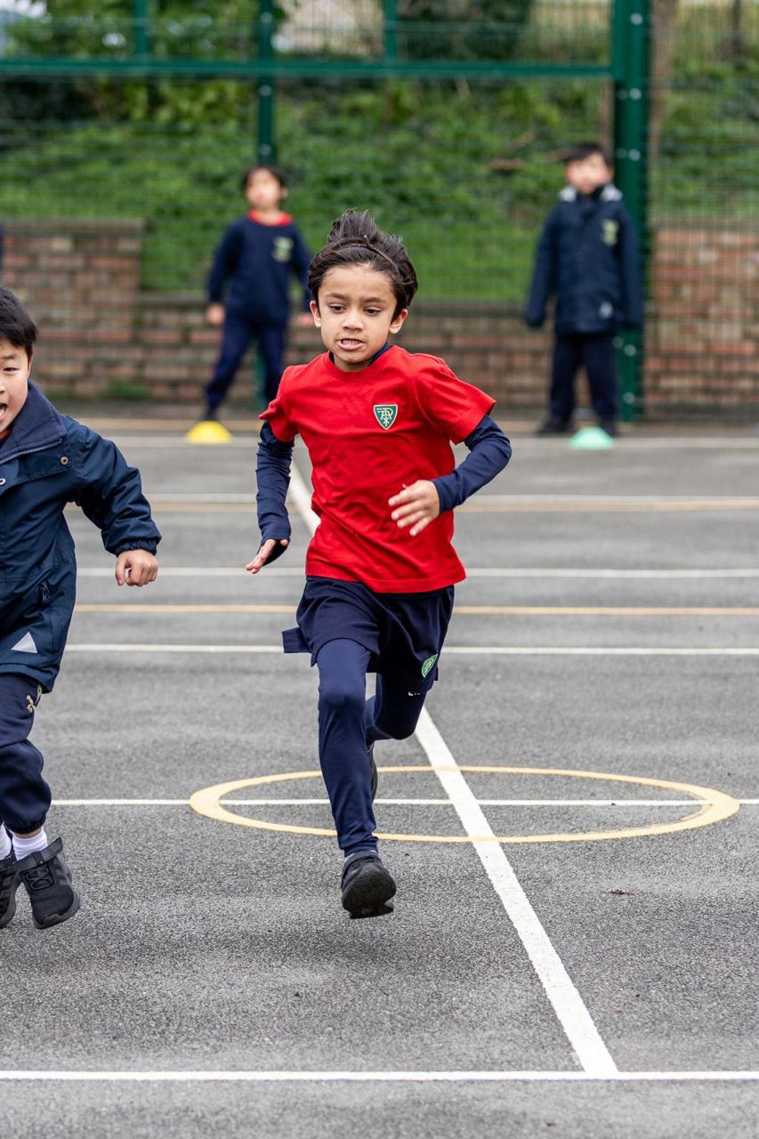 A pupil sprinting in PE kit at Vita et Pax Preparatory School