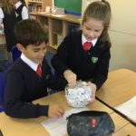 student adding tin foil to a ball