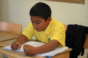 a student writing in his book