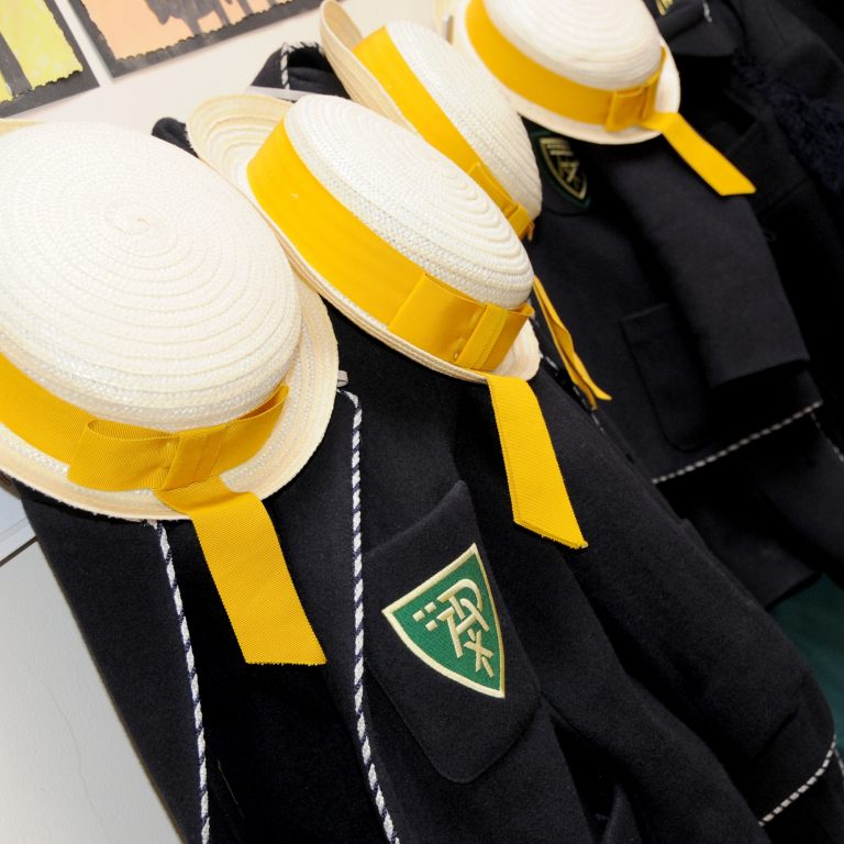 school blazers and hats hung up