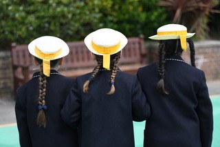 students wearing yellow hats