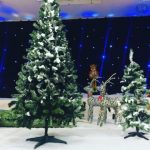christmas tree with fake snow, deer and other themed items