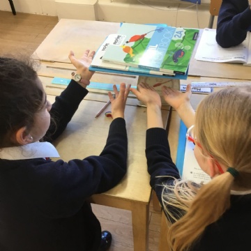 children stacking books