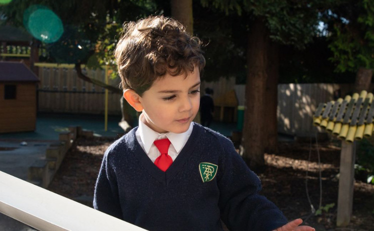 boy in school sweater