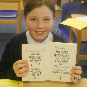 students showing book: The Girl Who Stole an Elephant