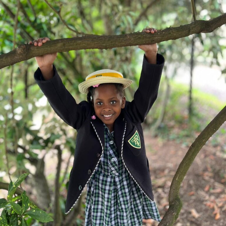 student holding onto a branch